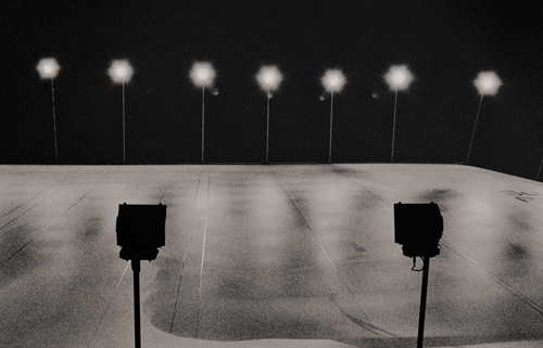 Advertising billboard illuminated by lights at night