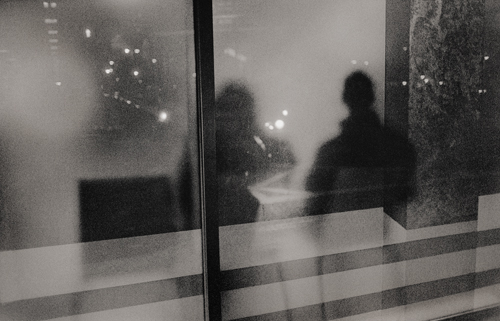 Seated figures seen through frosted window